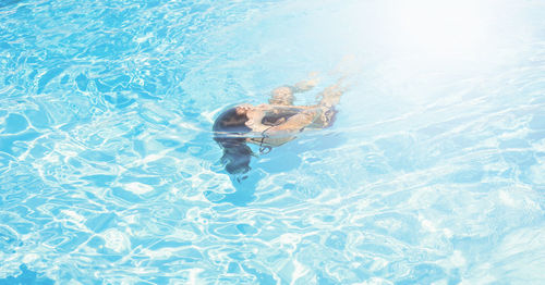 High angle view of woman swimming in pool