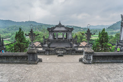 View of temple building against cloudy sky