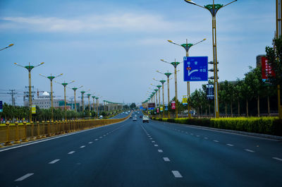 Vehicles on road against sky