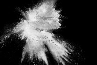 Defocused image of powder paints against black background