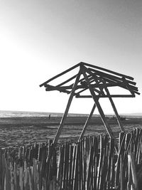 Lifeguard hut on beach against clear sky