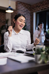 Happy businesswoman at desk in office