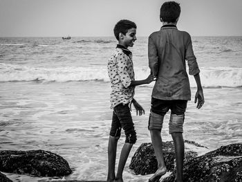 Boys standing in sea