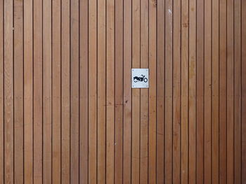 Full frame shot of sign on wooden wall