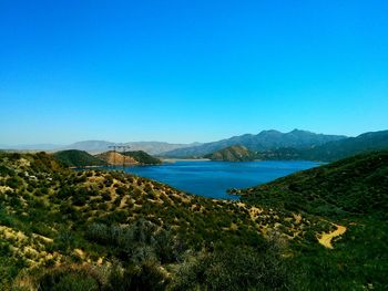 Scenic view of mountains against clear blue sky