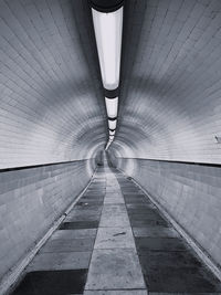 Rear view of man walking on escalator