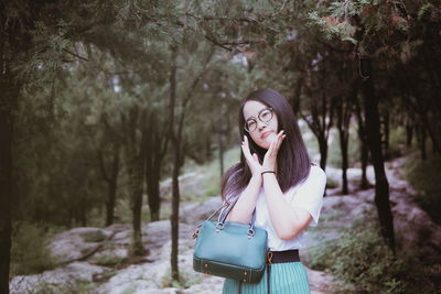 Woman standing in forest