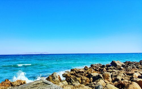 Scenic view of sea against clear blue sky