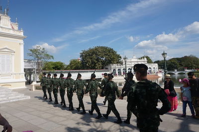 Group of people in park against sky