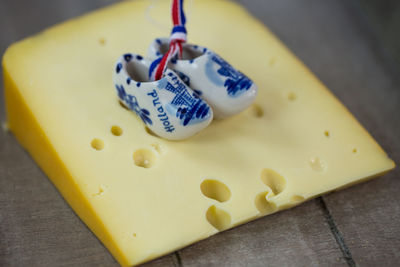 Close-up of small clogs on cheese slice on table