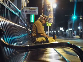 Man working on illuminated street at night