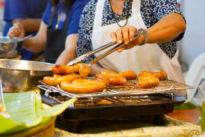 Midsection of man preparing food