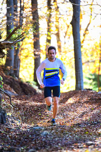 Full length portrait of man running on road