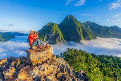 Asian girl on top viewpoint of nong khiaw - a secret village in laos. 