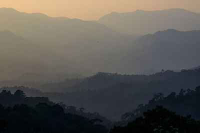 Scenic view of silhouette mountains against sky