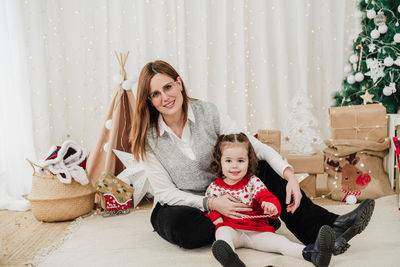 Young woman sitting on sofa at home