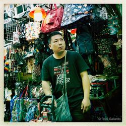 Full length of man looking at market