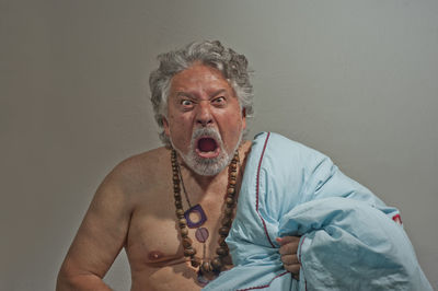 Portrait of man wearing mask against gray background