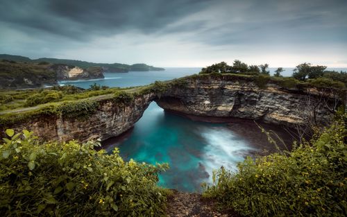 High angle view of sea and trees against sky