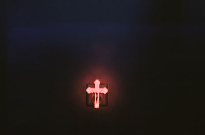 Close-up of light bulb over black background