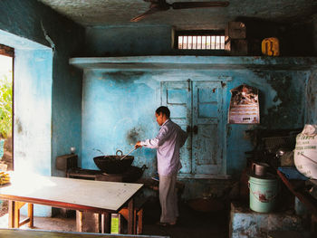 Full length of man standing in kitchen