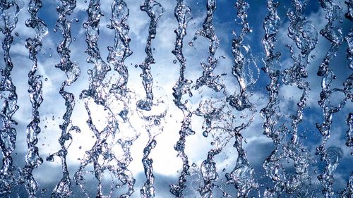 Full frame shot of water drops on blue glass