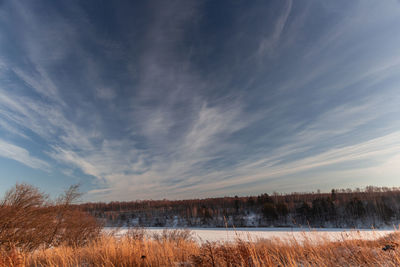 Scenic view of frozen lake against sky during winter