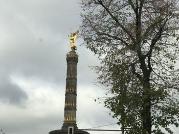 Low angle view of building against cloudy sky