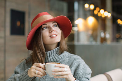Close-up of young woman having coffee