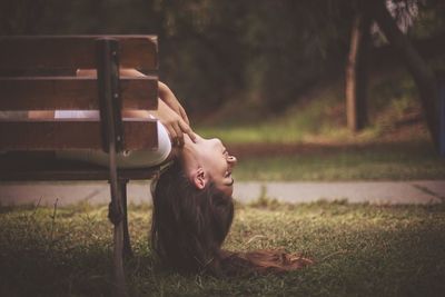 Young woman lying down on grass