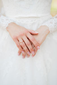 Close-up of woman hand on white wall