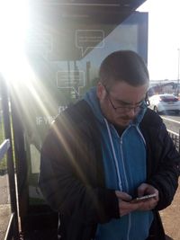 Midsection of man standing in sunlight