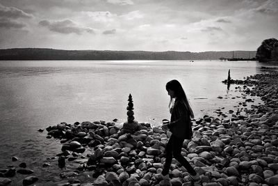 Full length of man with lake against sky