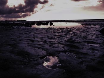 Scenic view of sea against cloudy sky