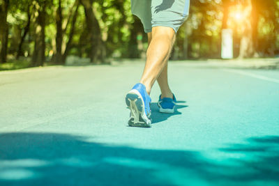 Low section of man wearing shoe