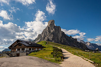Castle by mountain against blue sky
