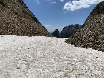 Surface level of rocky mountains against sky