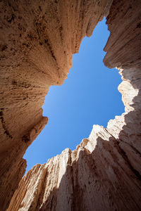 Low angle view of rock formation against clear blue sky. slot canyon 