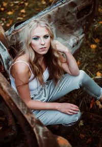 Portrait of young woman sitting outdoors