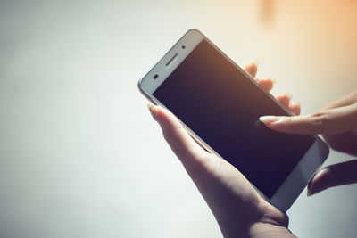 Close-up of hand holding mobile phone