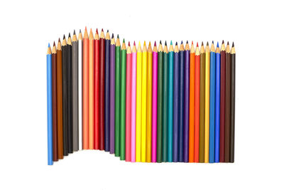 Close-up of multi colored pencils against white background