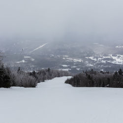 Scenic view of snow covered landscape against sky