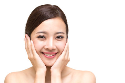 Portrait of a smiling young woman over white background