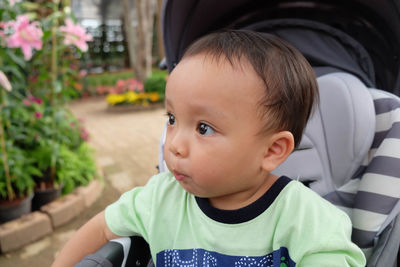 Close-up of cute girl sitting outdoors