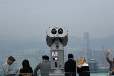 Coin-operated binoculars against people in city