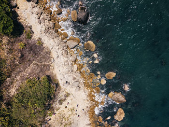 High angle view of rocks on sea shore - drone photo looking down 