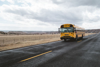 View of yellow road against cloudy sky