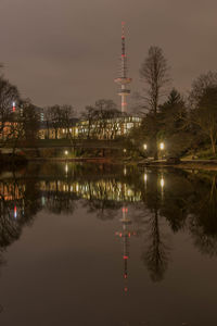 Reflection of buildings in lake at night