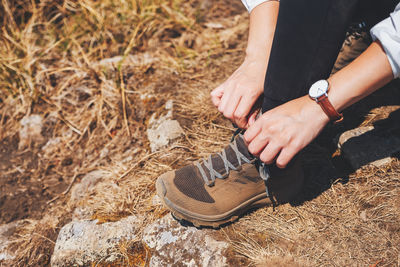 High angle view of woman tying shoelace