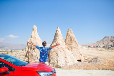 Low angle view of car on mountain against clear blue sky